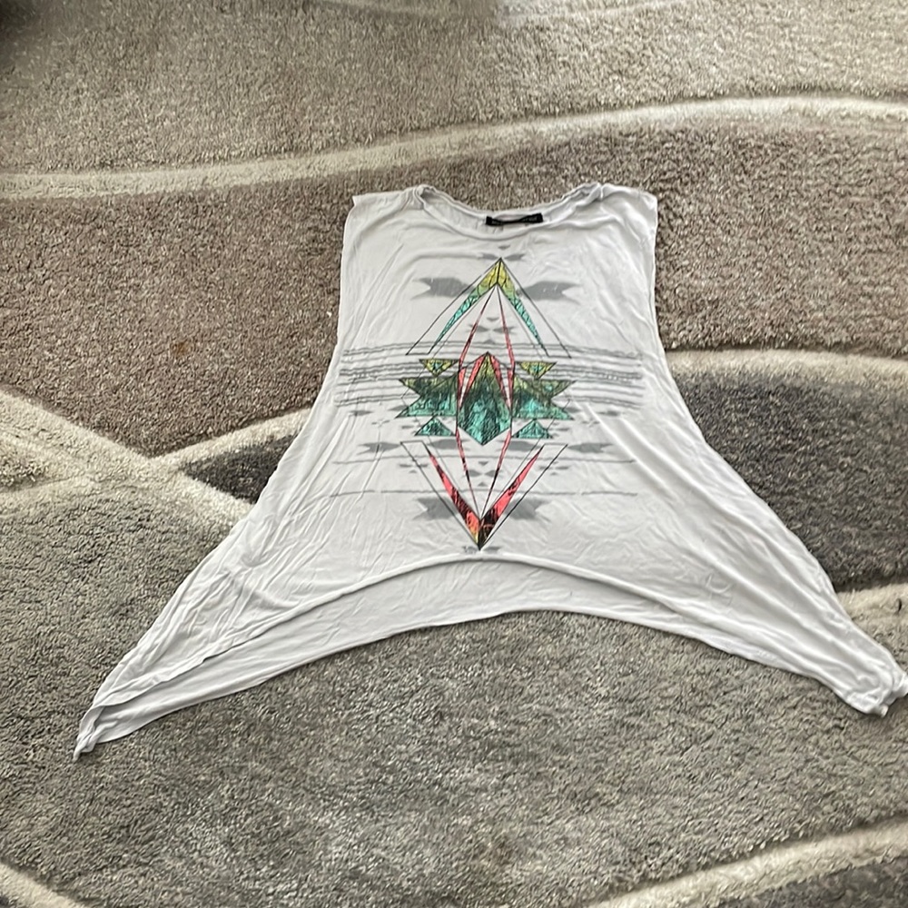 Sleeveless top with wide openings. Tribal design print on front. Used once.